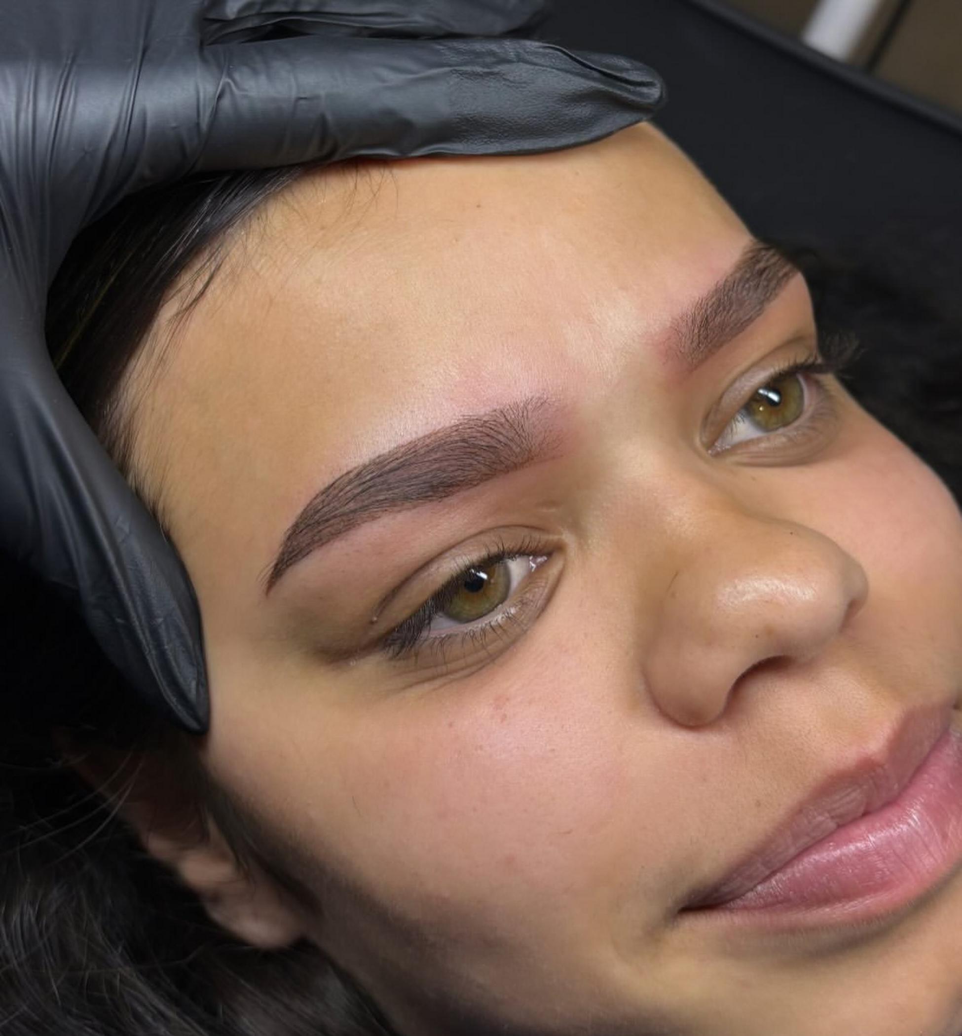 technician applying lip blush tattoo